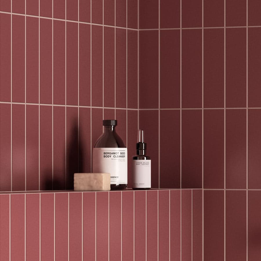 Shower shelf against red tiled walls, using Fugalite Color.